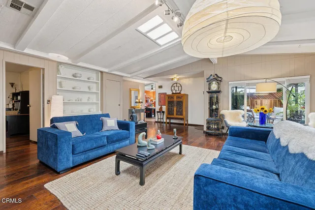 a living room with furniture and a book shelf