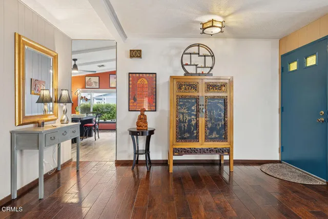 a dining room with furniture and wooden floor