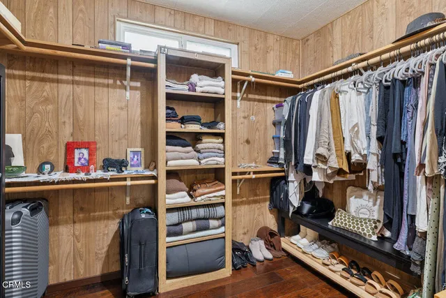 a bedroom with furniture and a flat tv screen