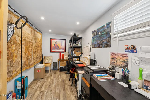 a view of a studio with wooden floor