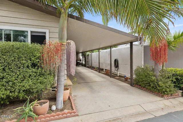 a kitchen with stainless steel appliances granite countertop a kitchen island a stove a table and chairs