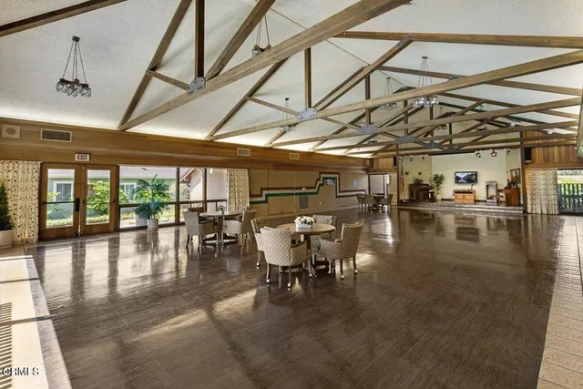 a living room with a table tennis table and paintings on the wall