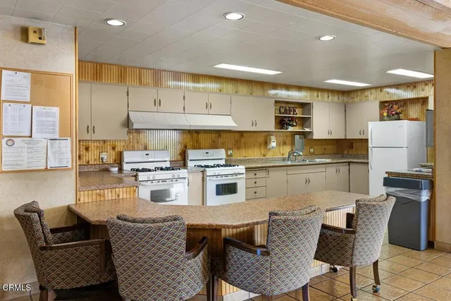 a room with furniture a large window and a rug