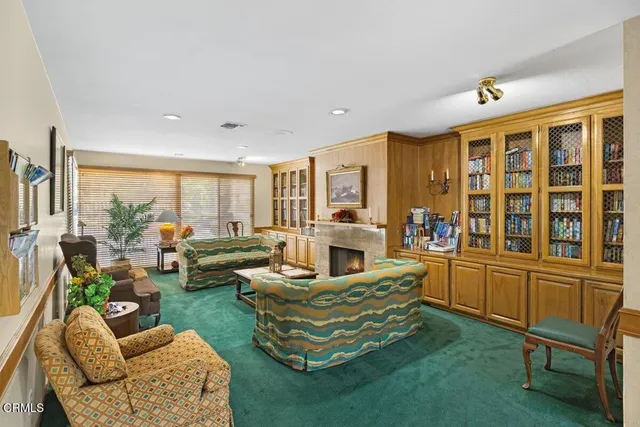 a living room with furniture and a floor to ceiling window