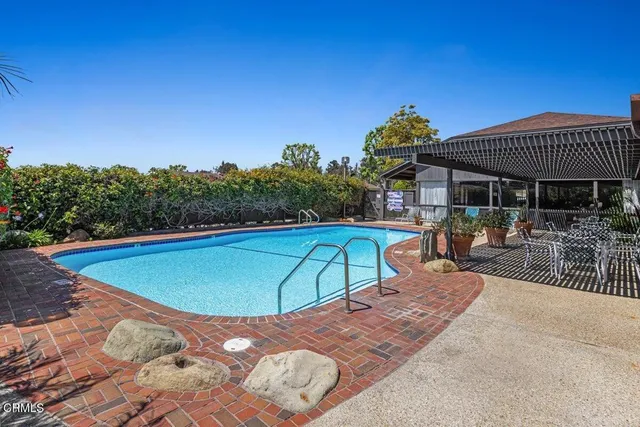 an outdoor space with pool and furniture
