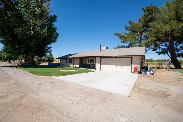 a bathroom with a granite countertop toilet sink and mirror