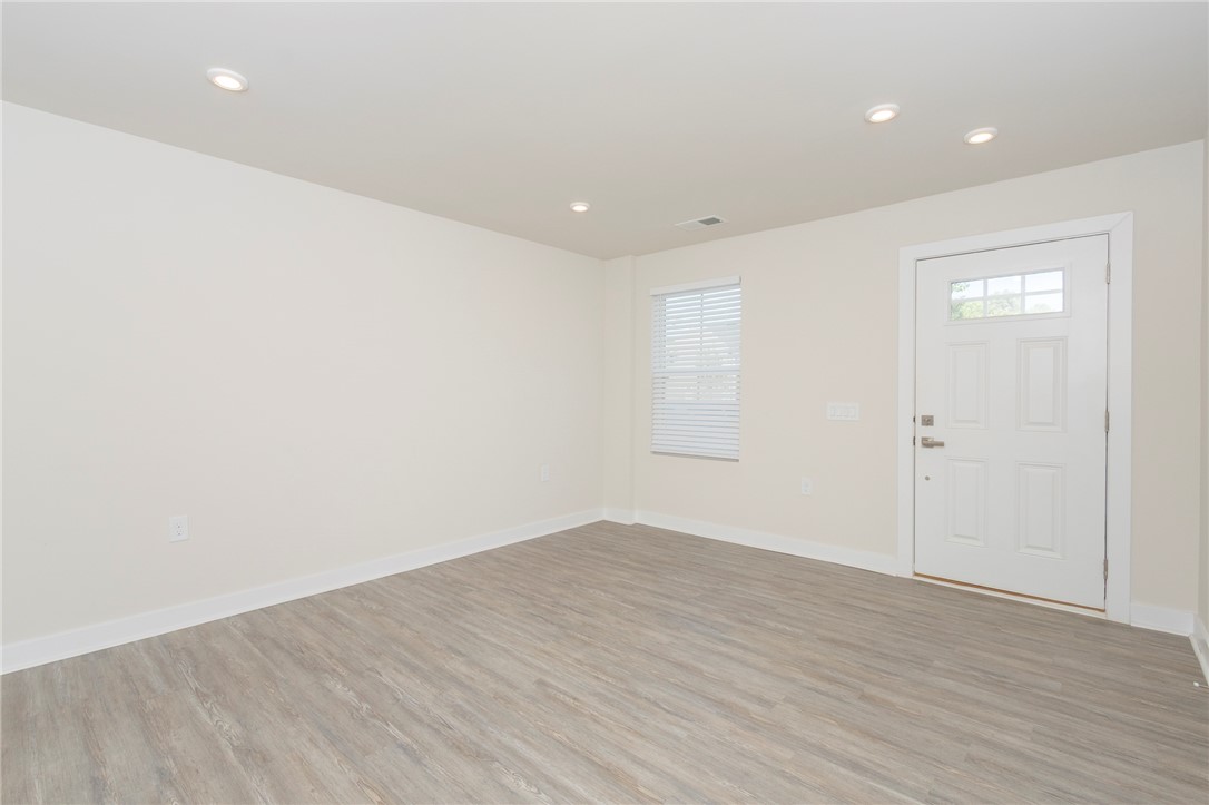 233 Scenic Road Anderson, SC 29621 - Photo 7 of 50 Recessed lighting illuminates this versatile entry space with light wood-style flooring and a window for natural illumination.