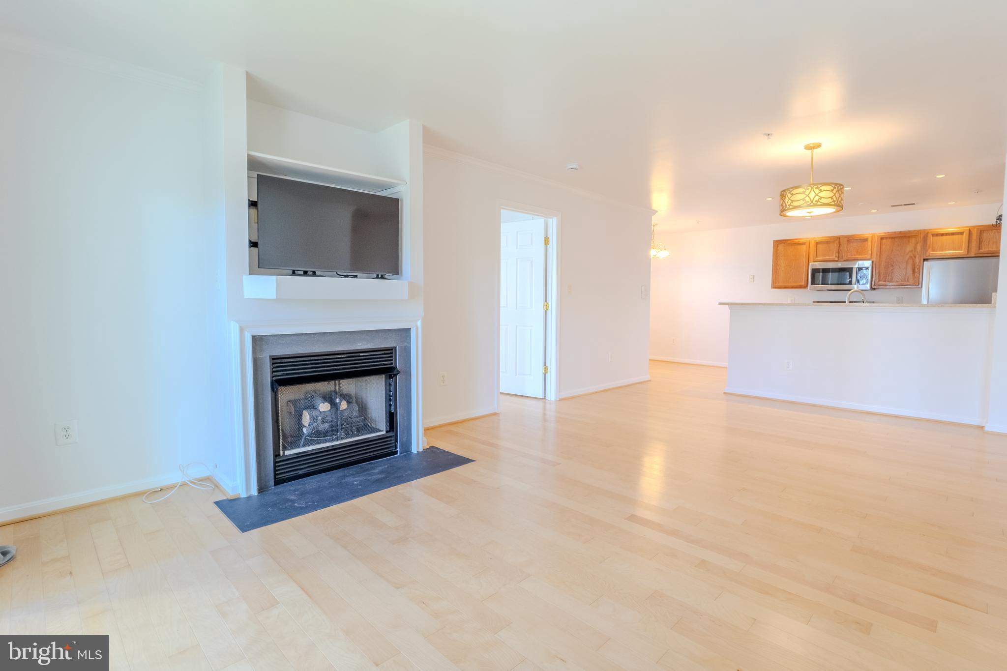 2015 Governor Thomas Bladen Way, Unit 104 Annapolis, MD 21401 - Photo 13 of 32 a view of an empty room with a fireplace