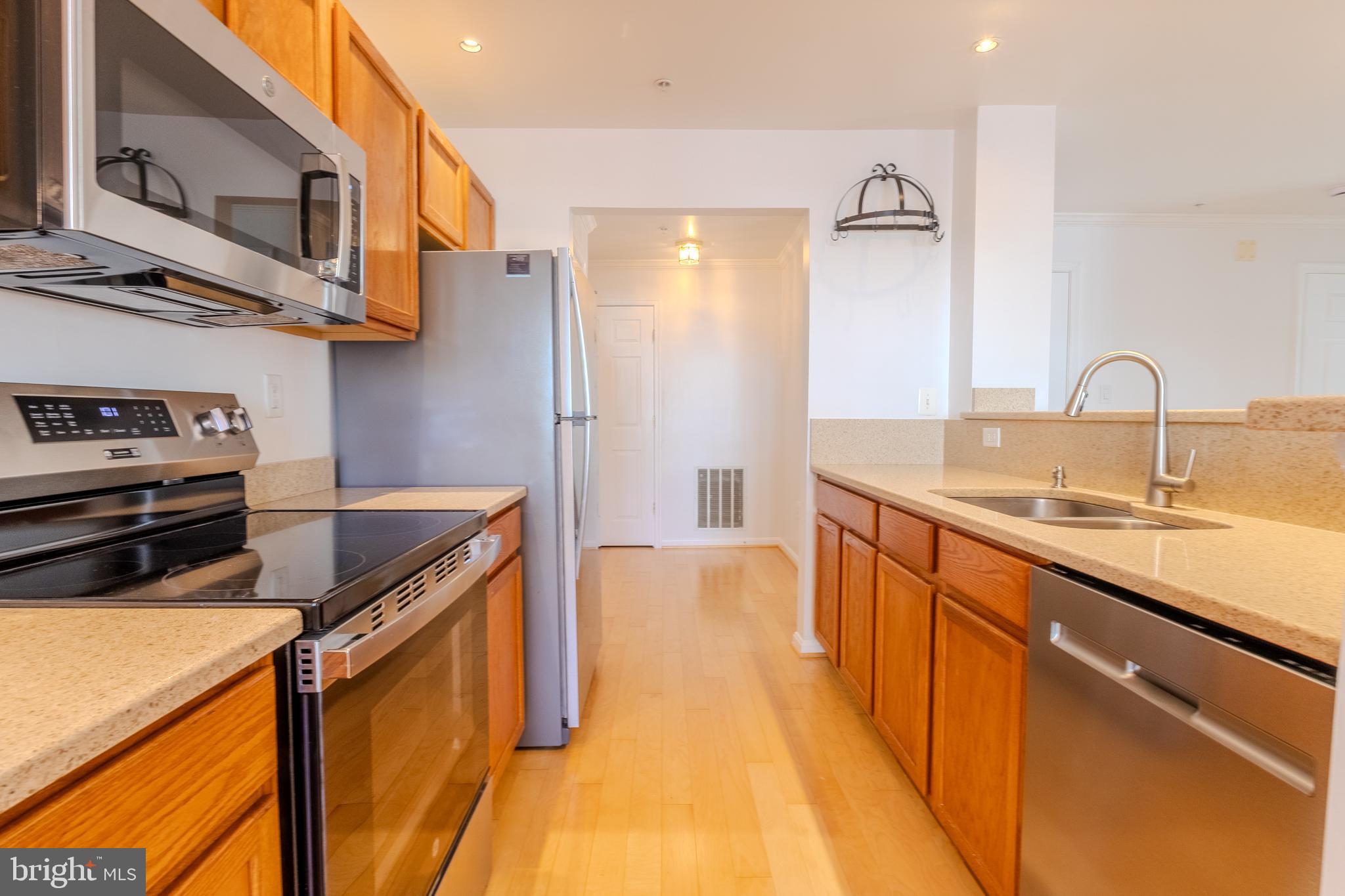 2015 Governor Thomas Bladen Way, Unit 104 Annapolis, MD 21401 - Photo 7 of 32 a kitchen with stainless steel appliances granite countertop a sink and a stove