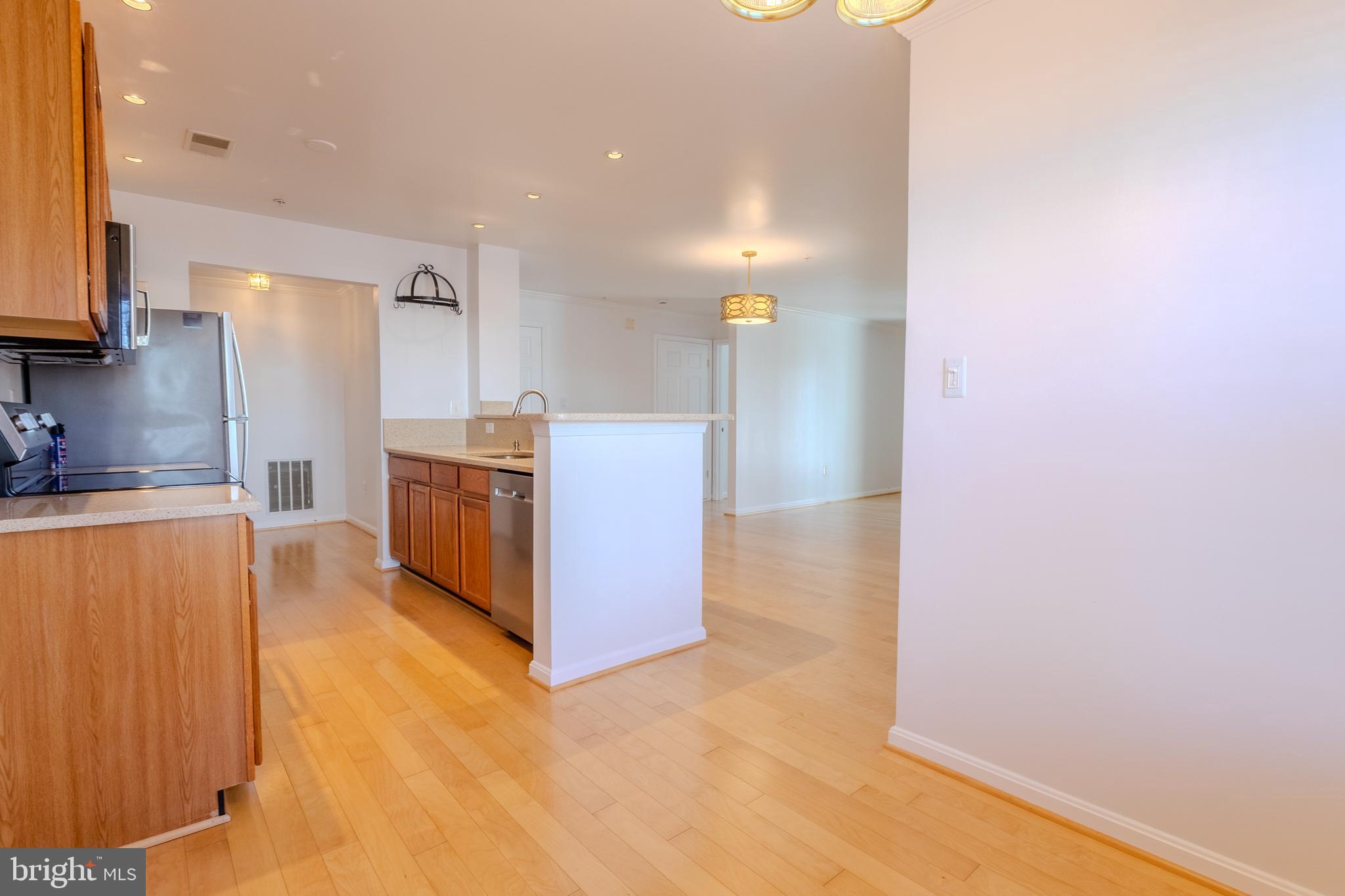 2015 Governor Thomas Bladen Way, Unit 104 Annapolis, MD 21401 - Photo 10 of 32 a kitchen with stainless steel appliances granite countertop a refrigerator and a sink