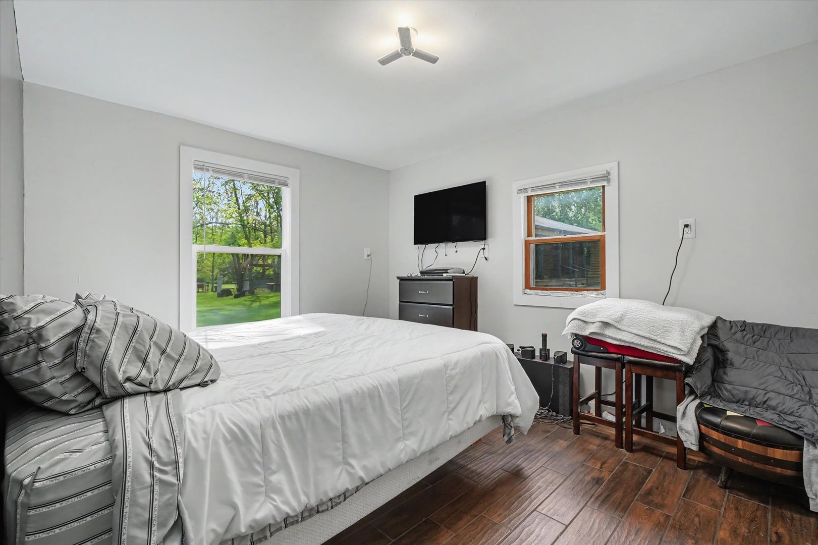 2431 North 1450 East Road Mansfield, IL 61854 - Photo 53 of 78 a bedroom with a bed wooden floor and a flat screen tv