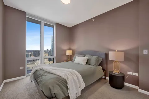 a bedroom with a bed and a lamp