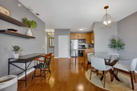 a view of a dining room with furniture and wooden floor