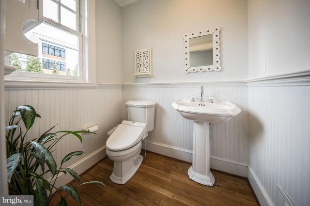 a bathroom with a sink toilet and a mirror