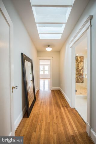 a view of a room with wooden floor and a window