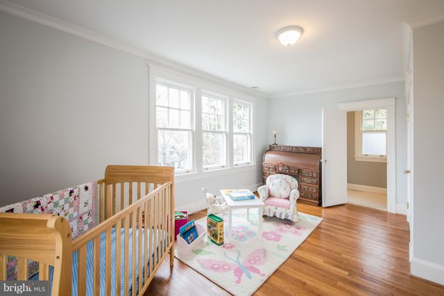 a bedroom with furniture and wooden floor