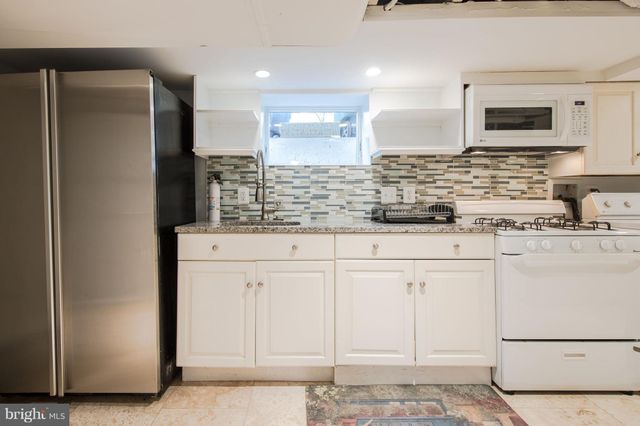 a kitchen with stainless steel appliances granite countertop a refrigerator and a stove