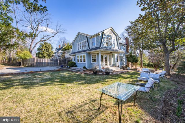 a view of a house with swimming pool and sitting area