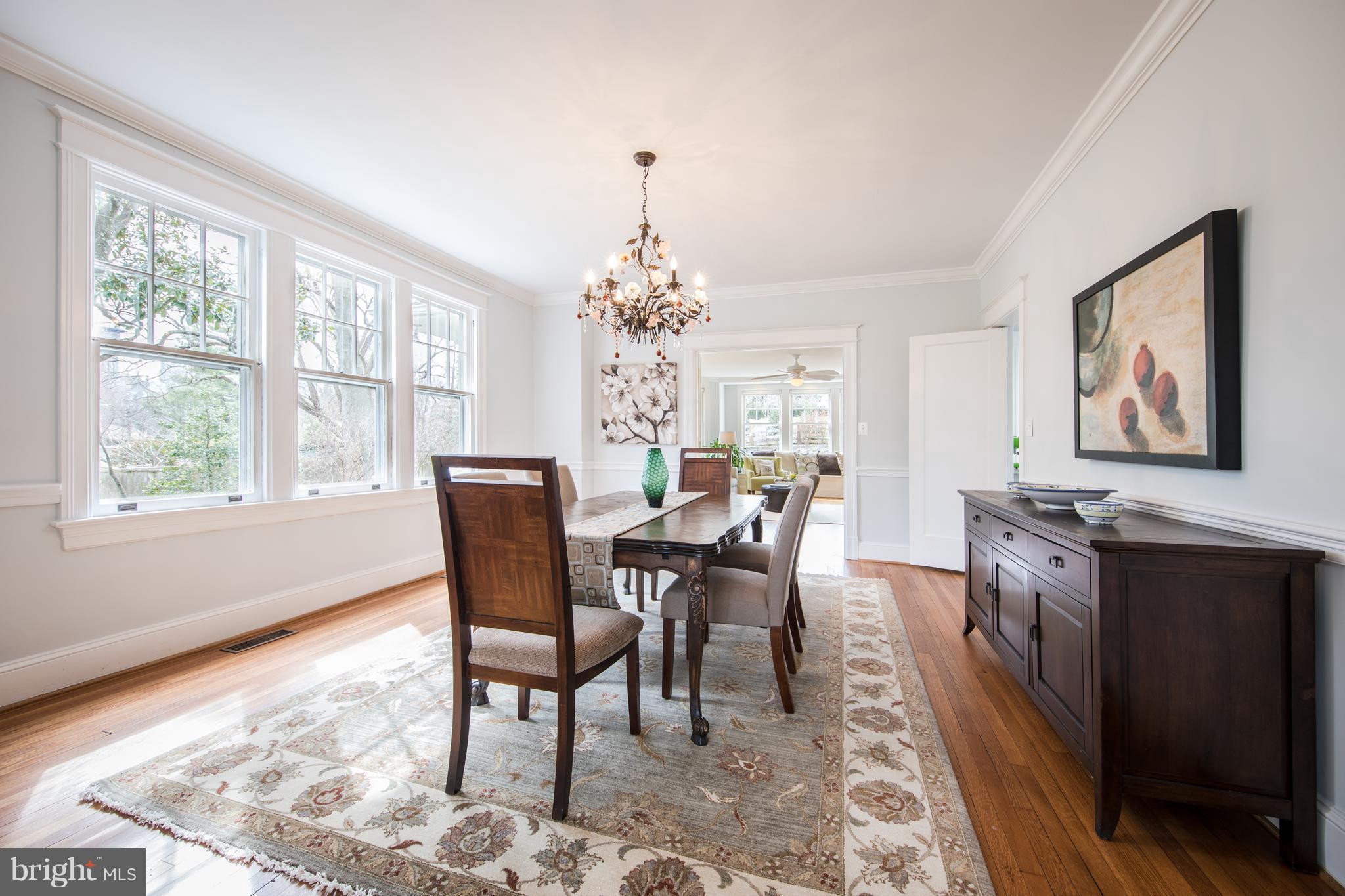 3430 34th Place Northwest Washington, DC 20016 - Photo 7 of 29 a dining room with chandelier and wooden floor