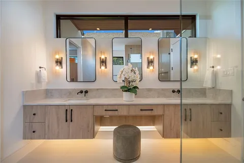 a bathroom with a double vanity sink and a mirror