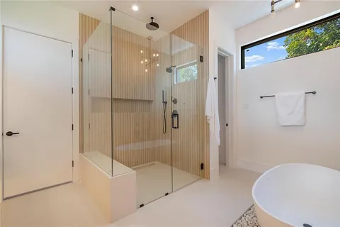 a bathroom with a shower and a tub