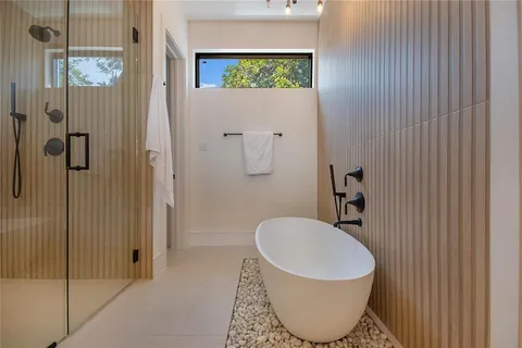 a bathroom with a toilet sink and shower