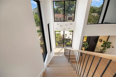 a view of a balcony with wooden floor and windows