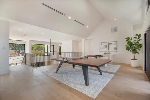 a living room with furniture a table and a potted plant