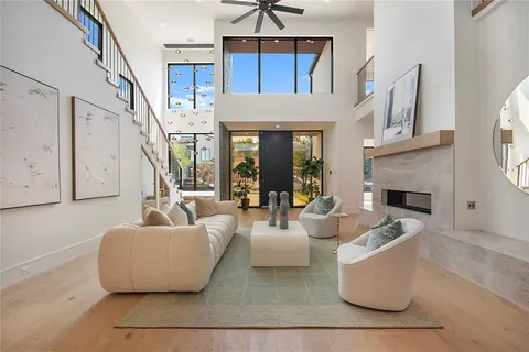 a living room with fireplace furniture and a chandelier