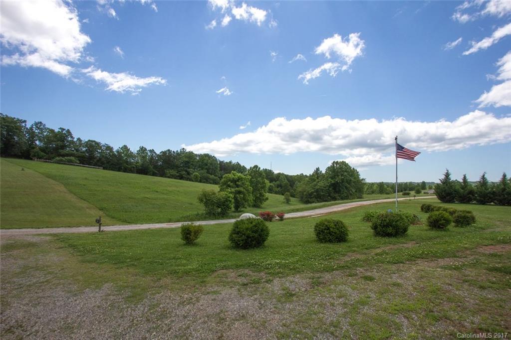 150 Buck Branch Rd Mill Spring Mill Spring, NC 28756 - Photo 2 of 22 a view of a golf course with a lake