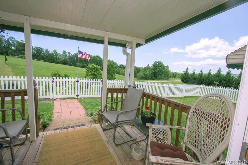 150 Buck Branch Rd Mill Spring Mill Spring, NC 28756 - Photo 13 of 22 a view of a two chairs in the deck