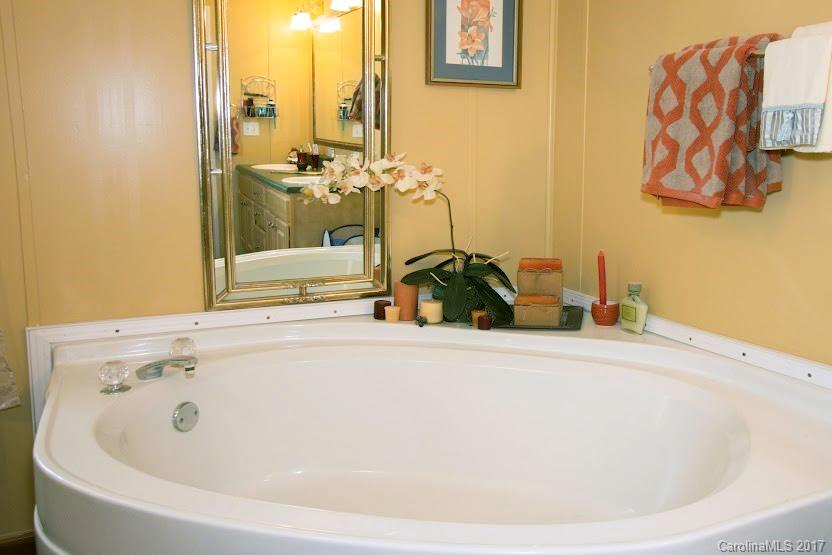 150 Buck Branch Rd Mill Spring Mill Spring, NC 28756 - Photo 18 of 22 a bathroom with a tub