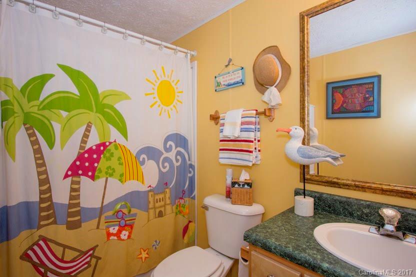 150 Buck Branch Rd Mill Spring Mill Spring, NC 28756 - Photo 20 of 22 a bathroom with a toilet sink and mirror