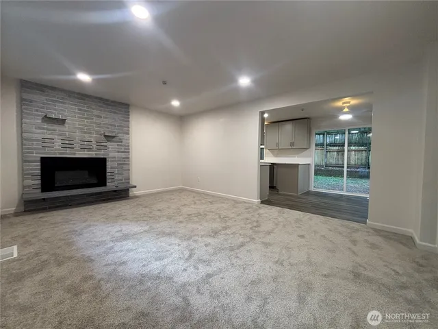 an empty room with furniture and a fireplace