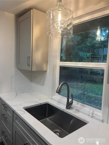 a kitchen with a sink and a mirror