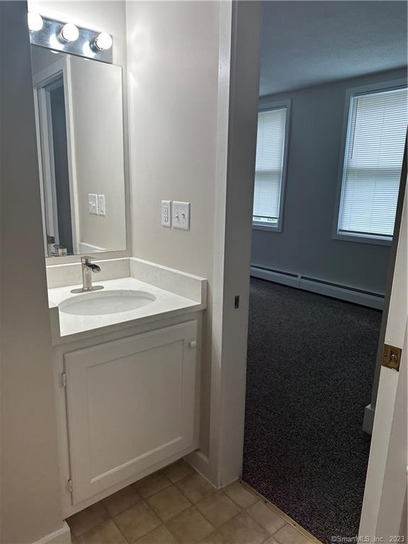 21 Wall Street, Unit 1E Cromwell, CT 06416 - Photo 14 of 16 a bathroom with a sink and a mirror