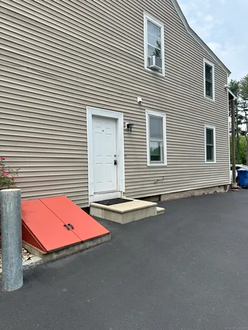 a backyard of a house with table and chairs