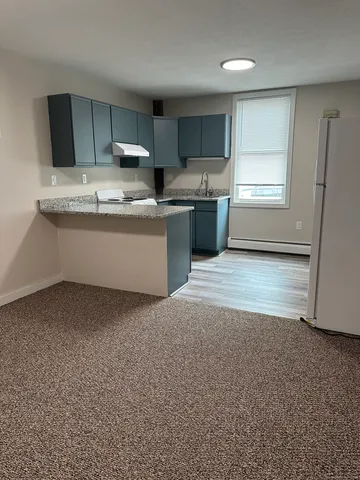 a kitchen with stainless steel appliances granite countertop a refrigerator sink and cabinets