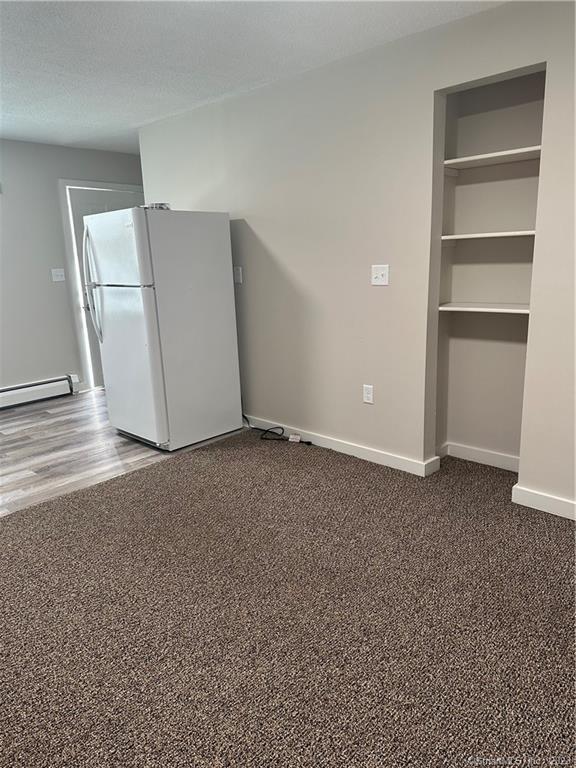 21 Wall Street, Unit 1E Cromwell, CT 06416 - Photo 9 of 16 a view of a room with a refrigerator and cabinet