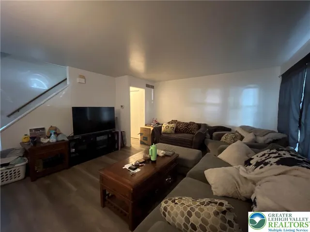 a living room with furniture and a flat screen tv
