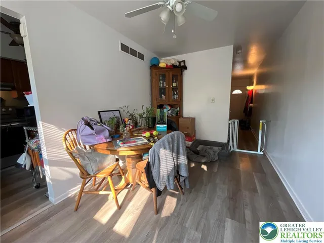 a view of a dining room with furniture and wooden floor