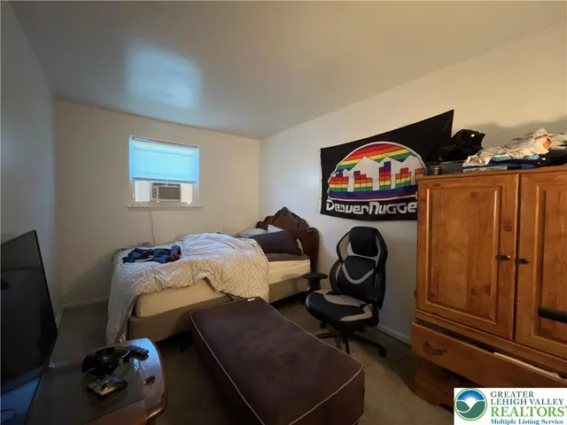 a bedroom with bed and a window