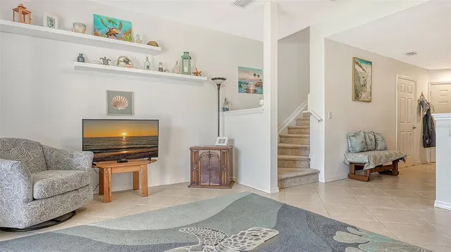 a living room with furniture and a flat screen tv