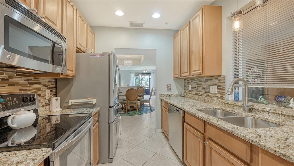 7240 Hamilton Road Bradenton, FL 34209 - Photo 18 of 46 a kitchen with stainless steel appliances granite countertop a sink stove and refrigerator