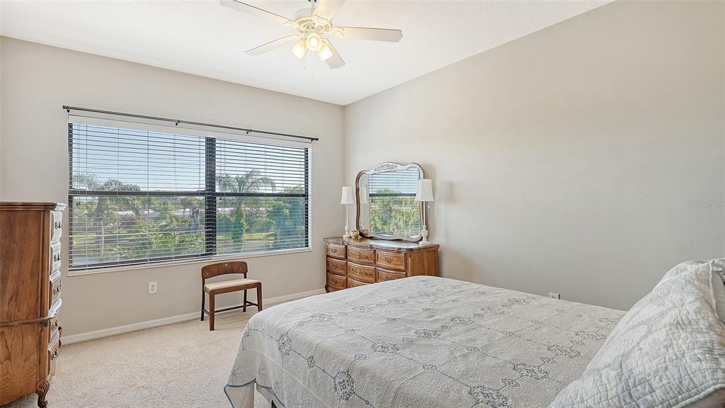 7240 Hamilton Road Bradenton, FL 34209 - Photo 23 of 46 a bedroom with a large bed and a window