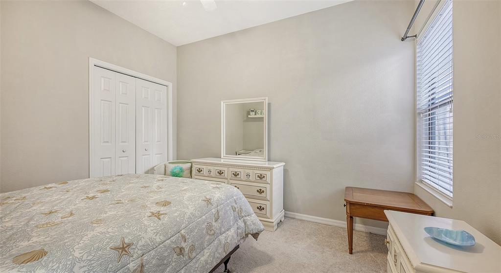 7240 Hamilton Road Bradenton, FL 34209 - Photo 27 of 46 a bedroom with a bed and a chair