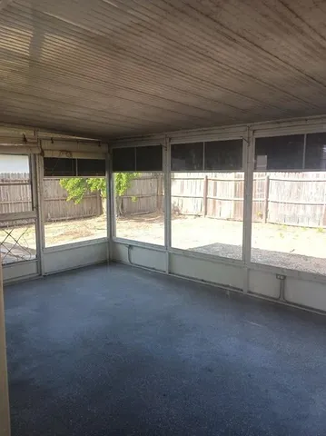 a view of an empty room with a large window