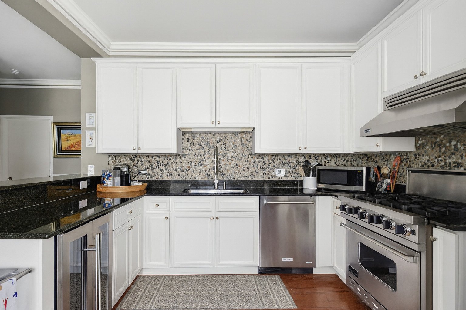 233 East 13th Street, Unit 1209 Chicago, IL 60605 - Photo 17 of 28 a kitchen with granite countertop a sink stove and cabinets