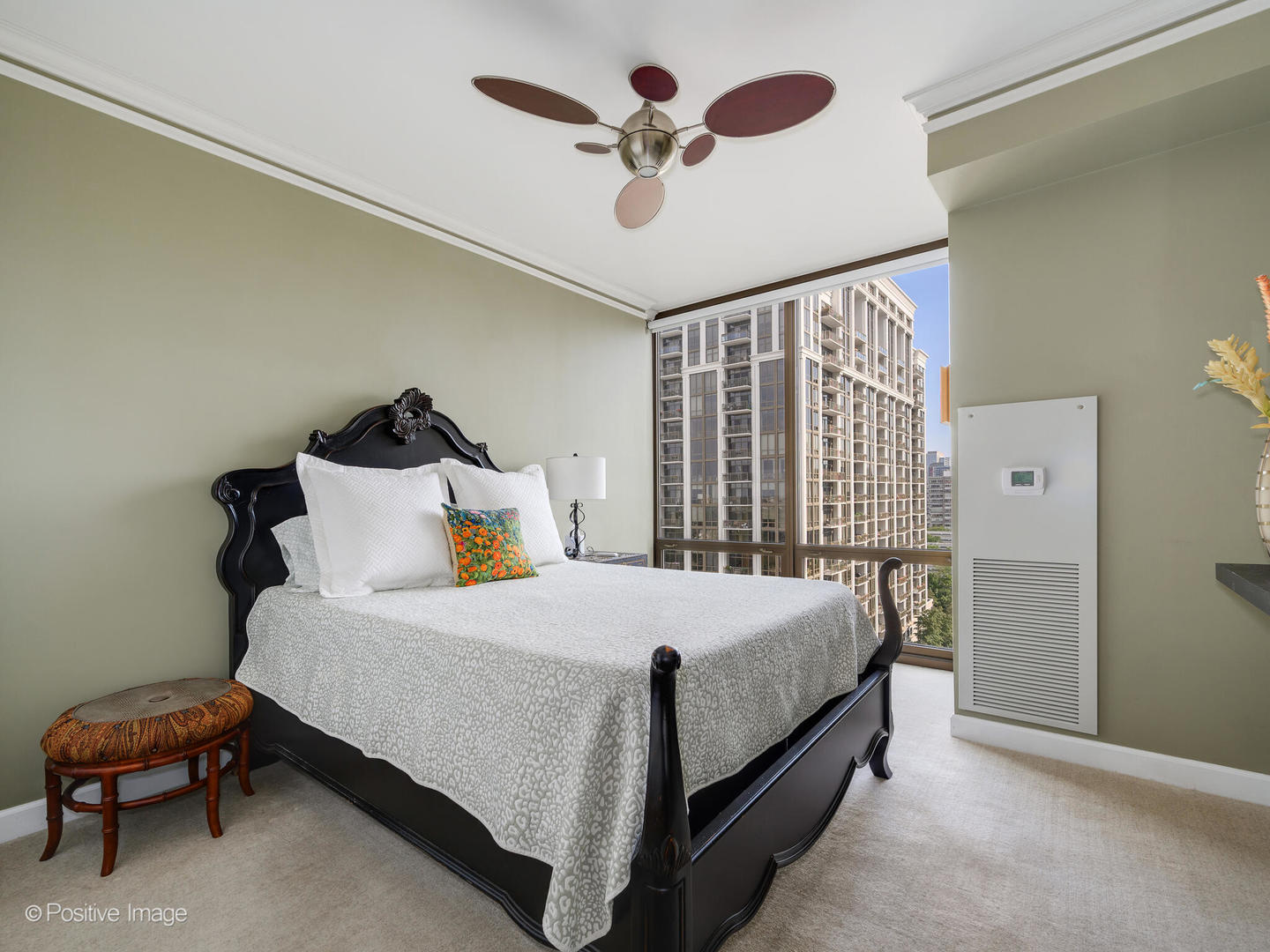 233 East 13th Street, Unit 1209 Chicago, IL 60605 - Photo 18 of 28 a bedroom with a bed and a chandelier