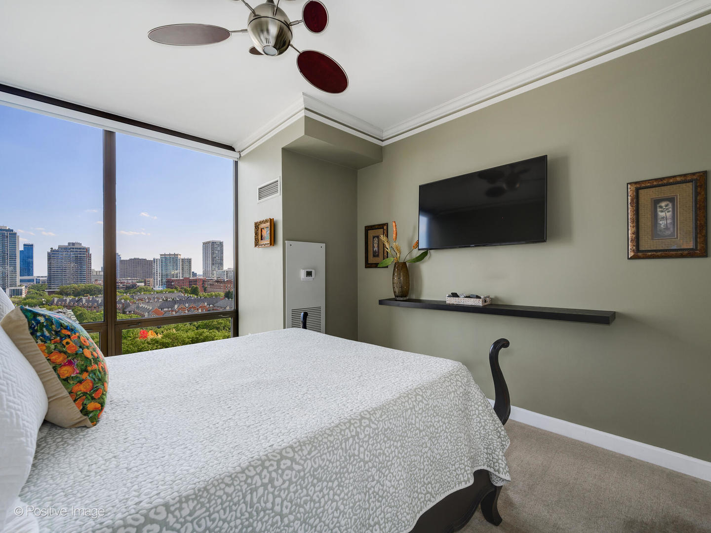 233 East 13th Street, Unit 1209 Chicago, IL 60605 - Photo 19 of 28 a bedroom with a bed and a flat screen tv